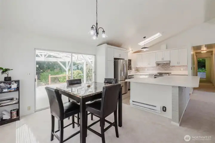 Bright dining area with large windows overlooking the lush side yard, creating a peaceful space to enjoy meals and gatherings. Conveniently located just off the kitchen with easy access to the covered outdoor entertaining area. Bright dining area with large windows overlooking the lush side yard, creating a peaceful space to enjoy meals and gatherings. Conveniently located just off the kitchen with easy access to the covered outdoor entertaining area.