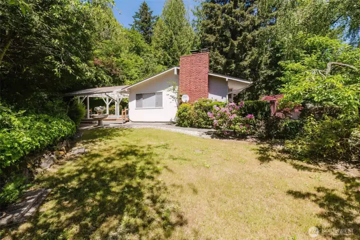 Spacious side yard surrounded by mature fruit trees and established landscaping offers a peaceful, park-like setting with plenty of room to relax, or entertain outdoors. Spacious side yard surrounded by mature fruit trees and established landscaping offers a peaceful, park-like setting with plenty of room to relax, or entertain outdoors.