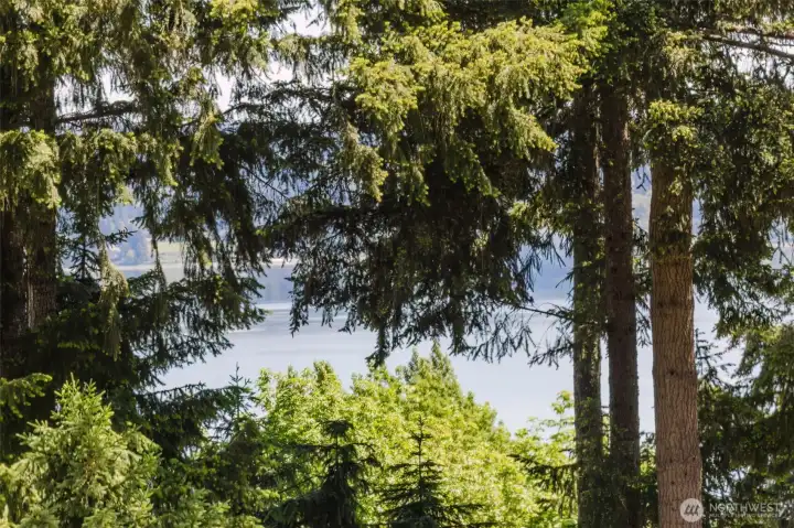 Wake up to peaceful water views and surrounding natural beauty right from the primary bedroom window, creating a calm and relaxing retreat. Wake up to peaceful water views and surrounding natural beauty right from the primary bedroom window, creating a calm and relaxing retreat.