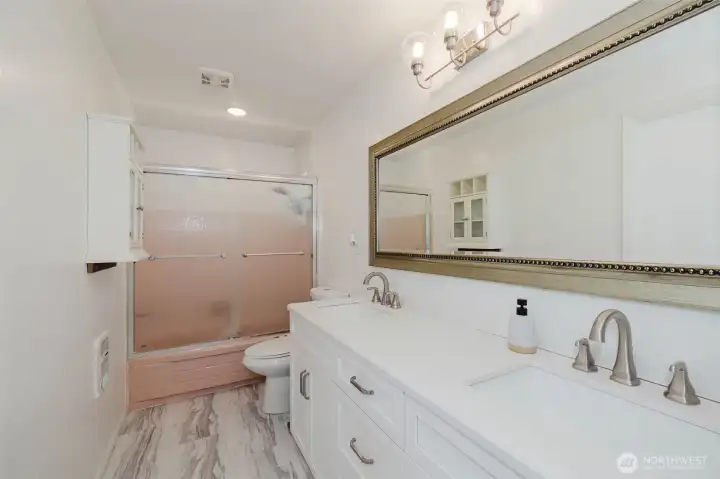Spacious main bathroom showcasing a large double vanity and stylish LVP flooring, both thoughtfully updated in 2023 for a fresh, modern feel. Spacious main bathroom showcasing a large double vanity and stylish LVP flooring, both thoughtfully updated in 2023 for a fresh, modern feel.