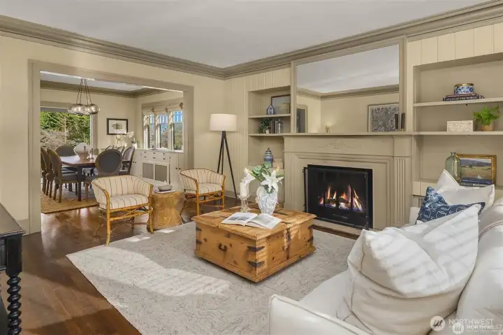 Grand living room with fireplace leads into dining room. Grand living room with fireplace leads into dining room.