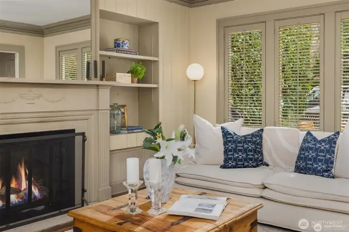 Cozy fireplace and built in book cases with shutters makes this desirable living room. Cozy fireplace and built in book cases with shutters makes this desirable living room.