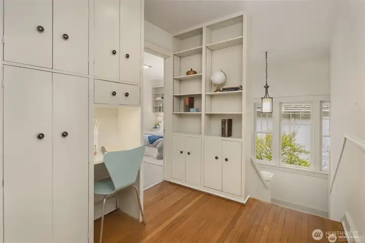 Darling buildins and desk in landing with original oak hardwood floors. Darling buildins and desk in landing with original oak hardwood floors.