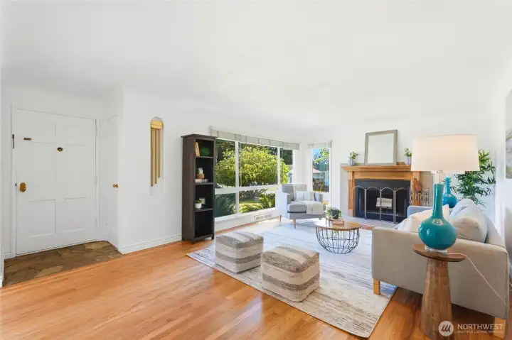 Entry opens into spacious living room with wood burning fireplace.