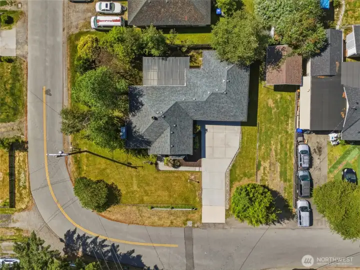 Home is situated on large 10,890 sf corner with with additional RV parking and carport/vehicle cover to right of garage for additional covered parking.