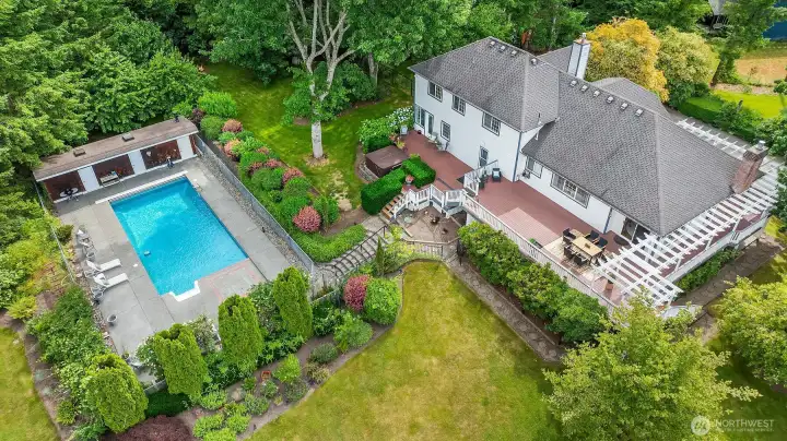 The backyard is designed for effortless entertaining, featuring an expansive deck that overlooks a sparkling crystal blue pool. An idyllic setting for unforgettable summer gatherings and leisurely afternoons. The backyard is designed for effortless entertaining, featuring an expansive deck that overlooks a sparkling crystal blue pool. An idyllic setting for unforgettable summer gatherings and leisurely afternoons.