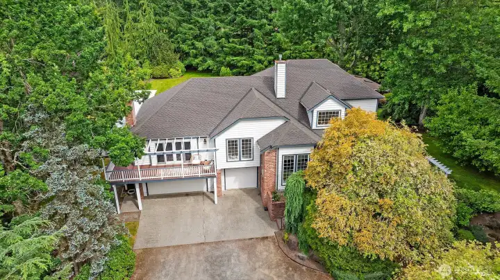 Surrounded by lush, mature landscaping, providing a wonderful sense of privacy. 3 car attached garage has ample room for a workshop and/or storage. Surrounded by lush, mature landscaping, providing a wonderful sense of privacy. 3 car attached garage has ample room for a workshop and/or storage.