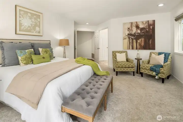 Double doors introduce the expansive primary suite, with abundant space for a comfortable sitting area and moments of quiet relaxation. Double doors introduce the expansive primary suite, with abundant space for a comfortable sitting area and moments of quiet relaxation.
