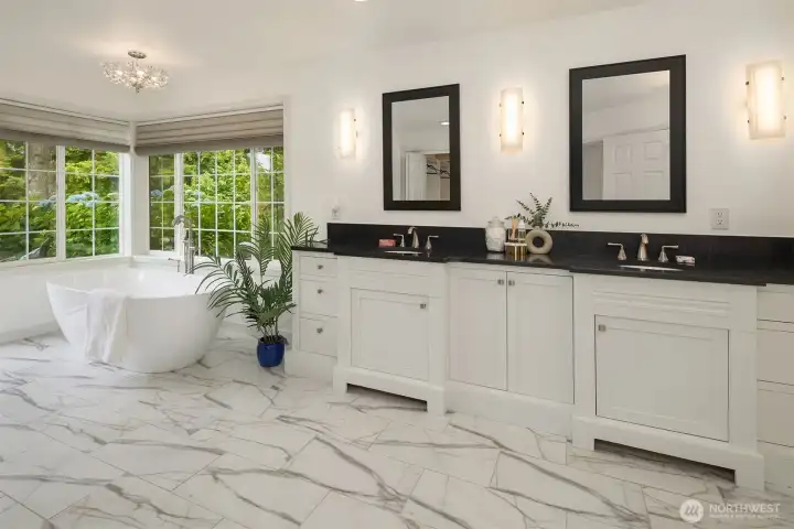 The tastefully remodeled primary bath offers a spa-inspired retreat with dual vanities, a luxurious soaking tub, and beautifully updated finishes. The tastefully remodeled primary bath offers a spa-inspired retreat with dual vanities, a luxurious soaking tub, and beautifully updated finishes.