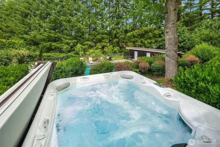 Extend your relaxation outdoors with a private hot tub just steps from the primary bath, perfectly positioned to overlook the pool and serene backyard retreat. Extend your relaxation outdoors with a private hot tub just steps from the primary bath, perfectly positioned to overlook the pool and serene backyard retreat.
