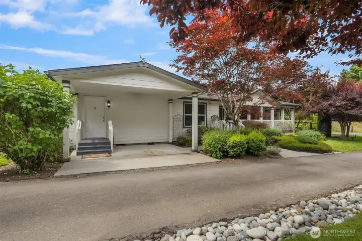 Another view of the manufactured home. Covered parking area for a small car or golf cart. Another view of the manufactured home. Covered parking area for a small car or golf cart.
