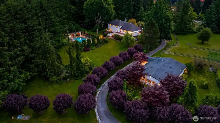 At twilight, the estate takes on a magical ambiance, highlighting the home's timeless elegance and beautifully landscaped surroundings. At twilight, the estate takes on a magical ambiance, highlighting the home's timeless elegance and beautifully landscaped surroundings.