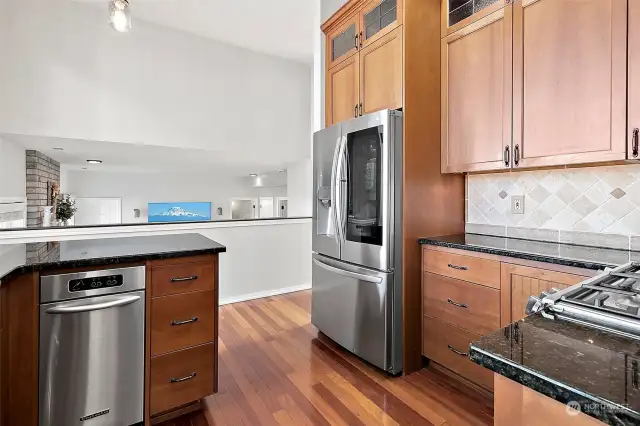 Stainless steel appliances, peekaboo fridge door, gas stove, trash compactor. Granite countertops, cherry hardwood floors. Under cabinet lighting.