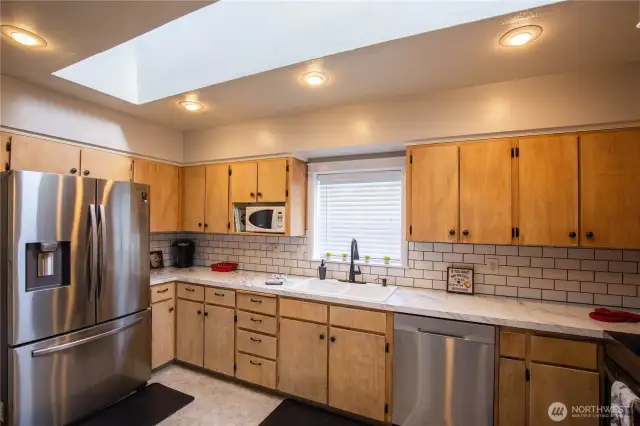 Lots of cabinets and countertop workspace in this light filled kitchen.