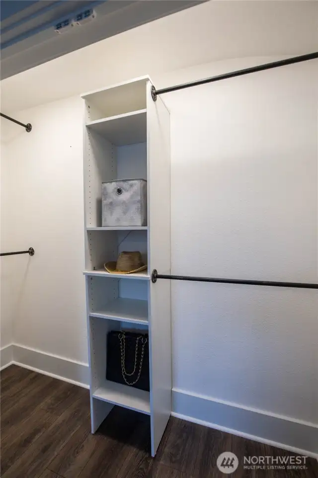 The primary bedroom has a unique closet with shelving and French doors.