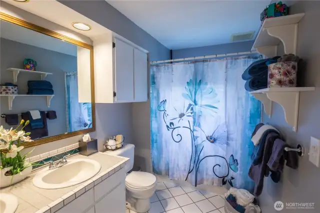 The full bathroom has dual sinks.