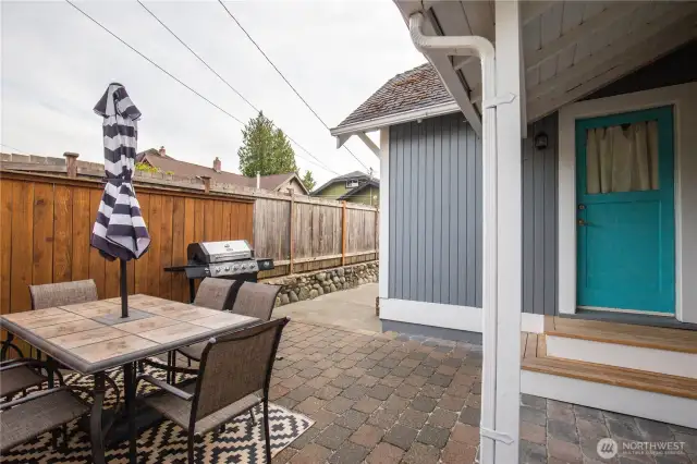 The fenced backyard has a nice patio area for outdoor entertaining and barbecues.