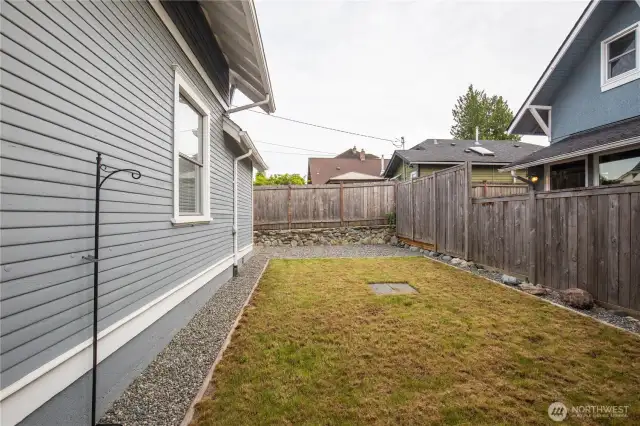 Flat Side yard with grassy area, room for a garden and fur babies.