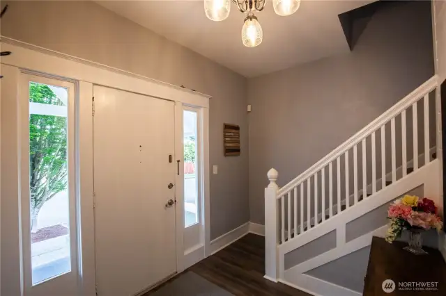 Another view of the foyer at the front door with the stairway leading to the upper floor and bedrooms.
