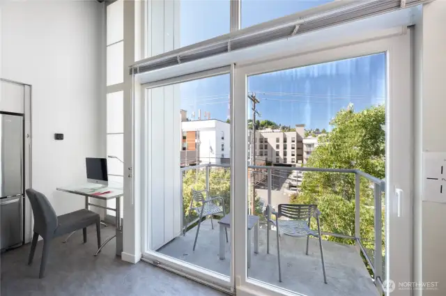 Windows from floor to ceiling. Sliding glass doors to the balcony.