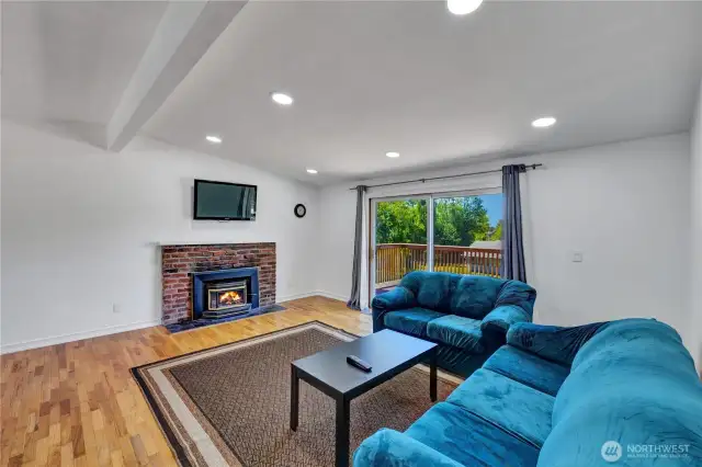 Upstairs living area with firpelace to cozy up to and beautiful wood floors.