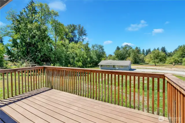 Deck off living area to relax and take in the spacious back yard views.