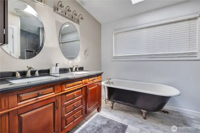 Updated bath with double sink and claw foot tub.