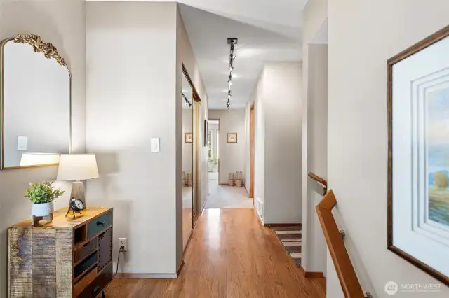 Space for an entry table and hardwoods down the hallway to the sleeping quarters.