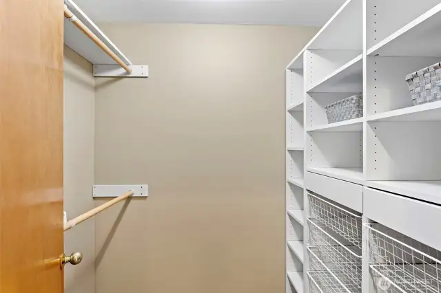 Primary walk-in closet with updated built-ins.
