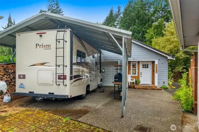 Side driveway provides access to ADU, RV carport and storage space behind garage door.