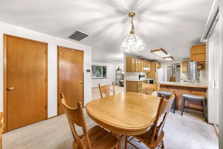 Dining area showing storage and kitchen with eating space