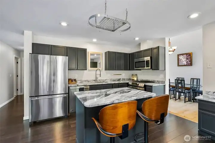 Modern kitchen showcasing a center island and granite countertops.
