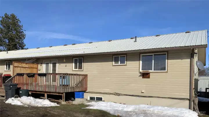 Backside of house with deck for each side