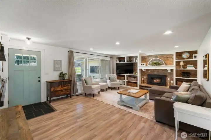 Large family room with built ins and wood fire insert