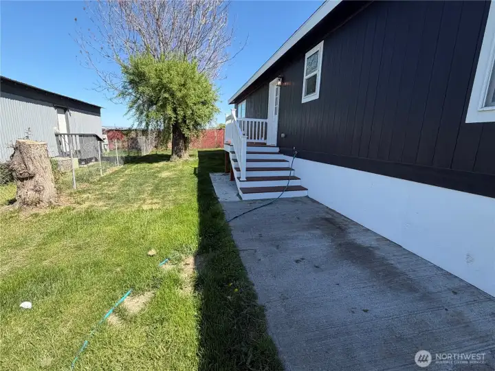 Side of home. Home is partially fenced.