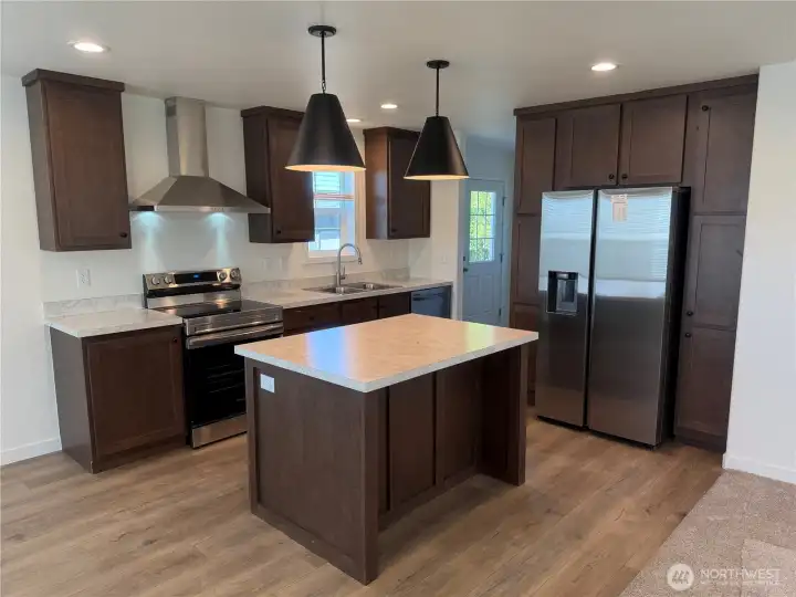 Large kitchen with island and eating bar.