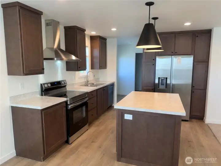 Kitchen with pantry and SS appliances.