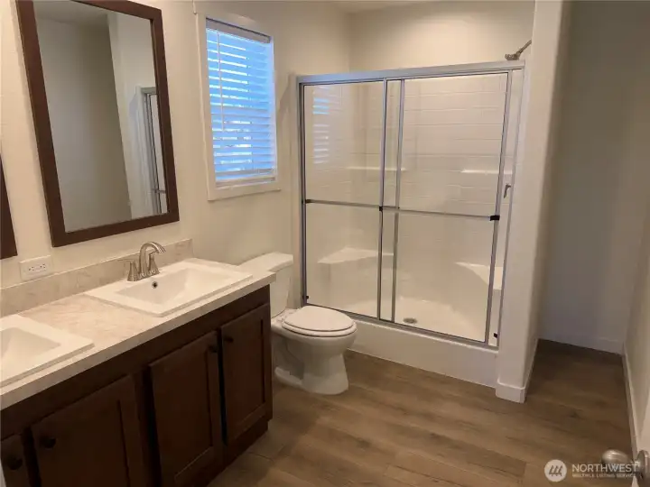 Primary bath with double vanities and walk in shower.