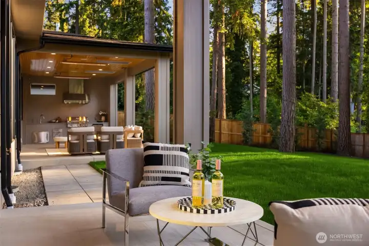 Opening to the mature landscape beyond, the private patio extends the junior suite outdoors, creating a peaceful retreat for guests, extended family, or everyday enjoyment.