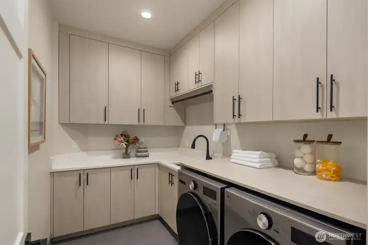 Thoughtfully located on both the main and upper levels, the dual laundry rooms reflect a practical approach to modern living, placing everyday convenience exactly where it's needed.