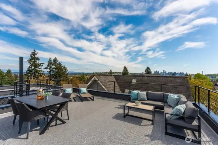 Views of the Olympics, Cascades, Rainier, Space Needle, & cityscape. Photo from model unit 4116 Burke Ave N, buyer to verify.