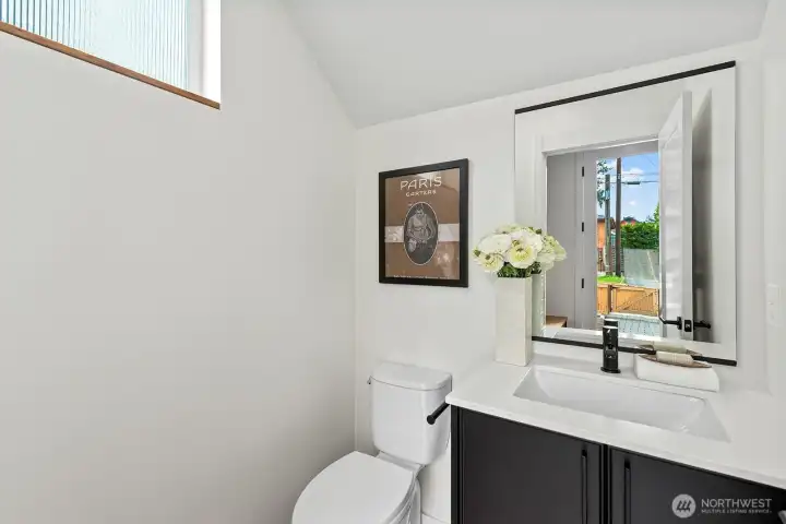 Coveted main floor powder room. Photo of model unit, 4116 B Burke Ave N - buyer to verify.