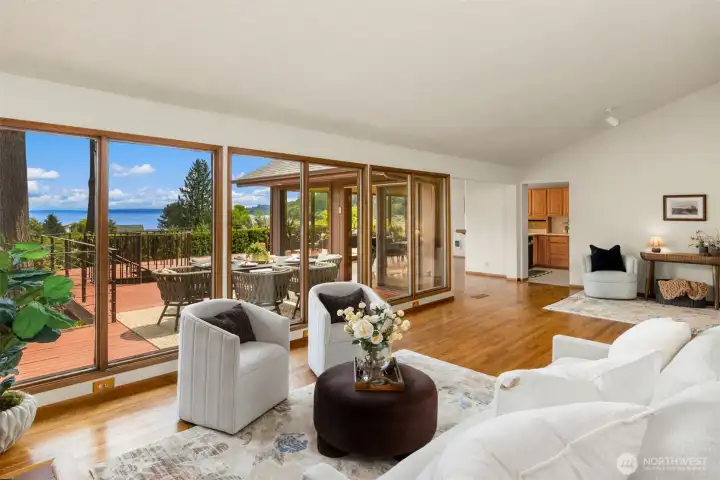 Natural light pours in through dramatic floor-to-ceiling windows.