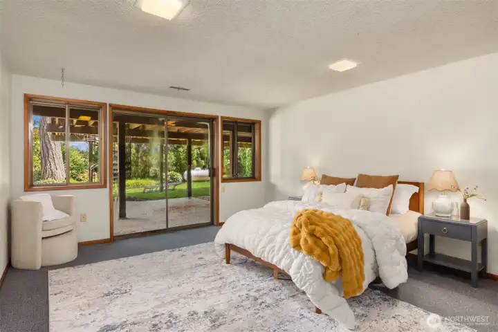 The walk-out daylight basement features a large bedroom with doors to the patio and backyard.