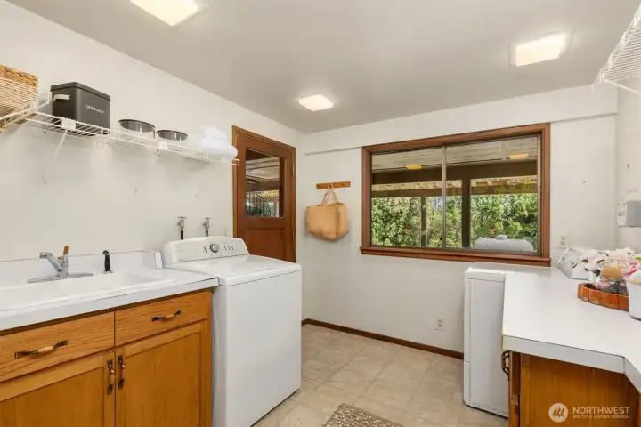 The laundry room has a convenient utility sink and access to the patio and backyard.