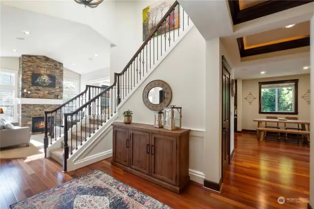 Here is anther entry view with beautiful cherry hard wood flooring through out most of main level leading your into family room kitchen and entry way.  Check out the stunning wood wrapped grand stair case with wrought iron railings and gorgeous white painted mill work.