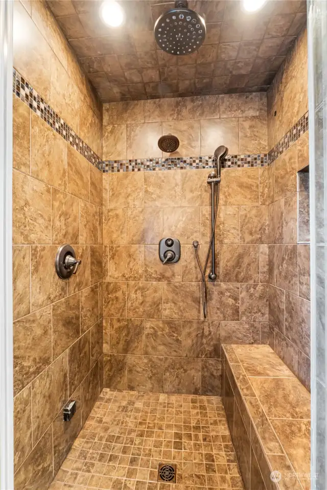 Check out this awesome tile shower big enough for multiple people with many shower heads and a steam shower experience also to clean out your system.