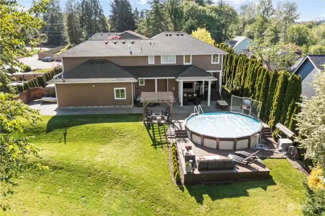 Here is view of this large 3/4 acre private manicured back yard with oversize above ground, heated pool and heat pump to keep house warm and cool year around.