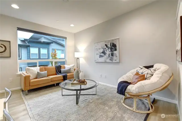 Open and airy living room is flooded with natural light.