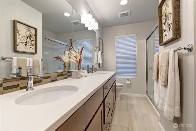 Two sinks and extra counter space in this primary bathroom.